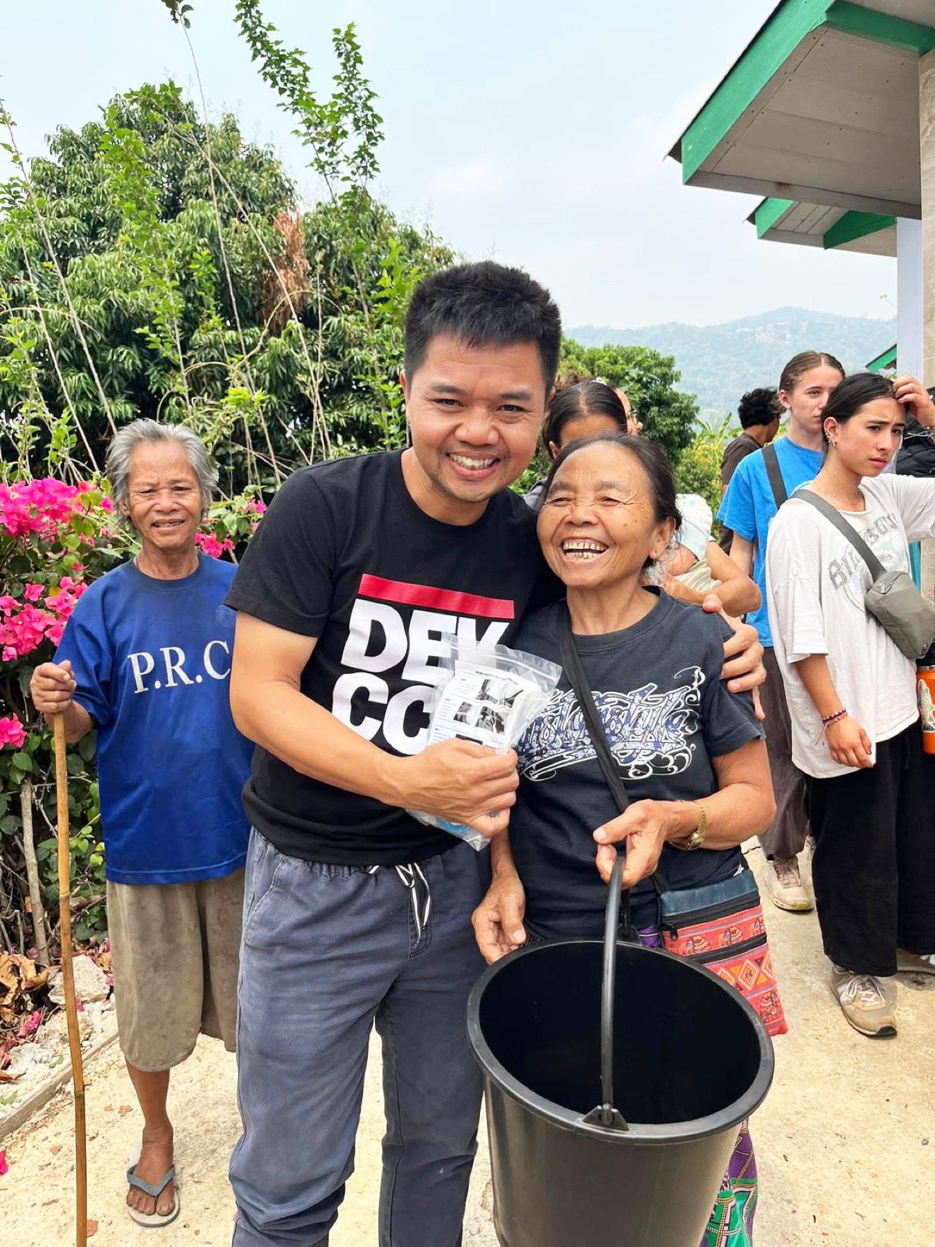A ministry partner embracing an older woman in the community